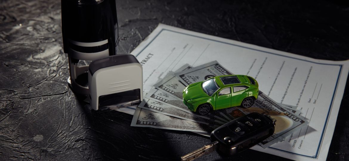 Purchase contract for a car with stamps, keys and toy car.